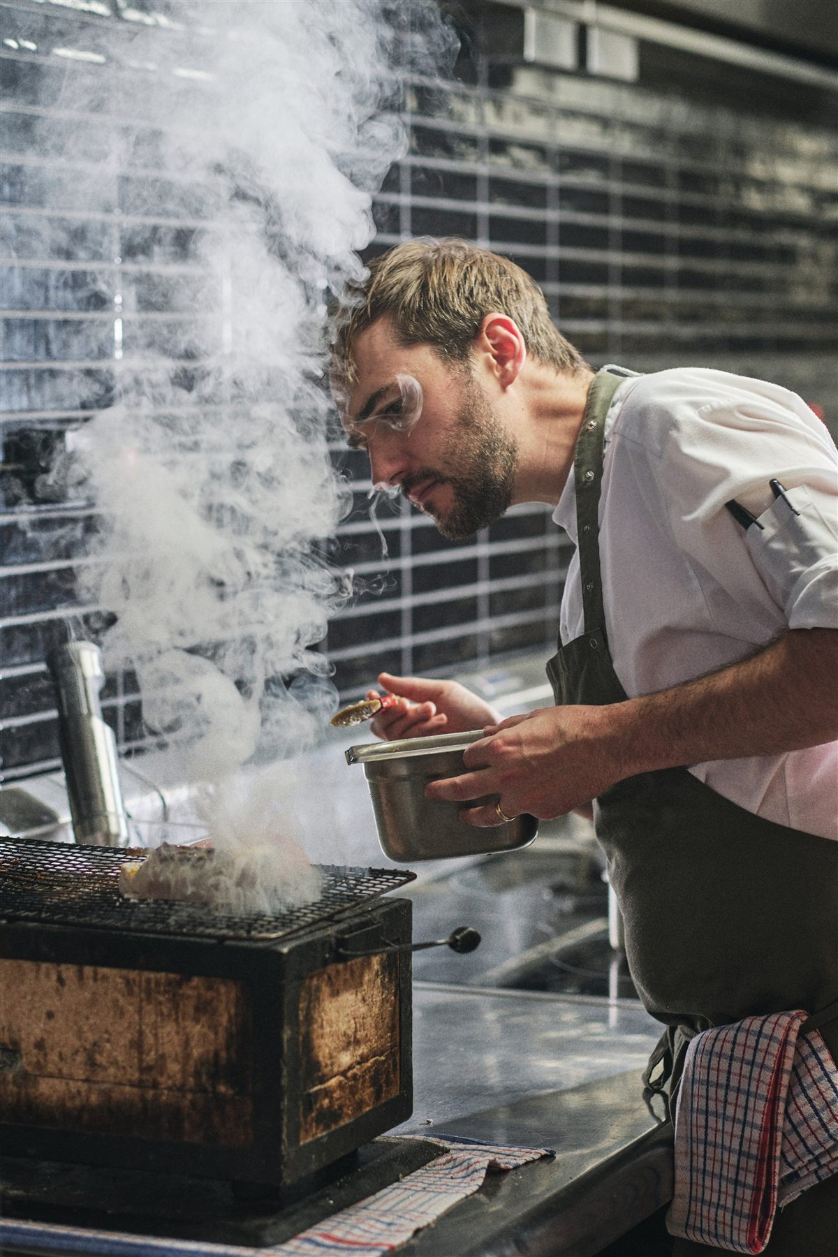 Stephen Nairn tending a charcoal grill